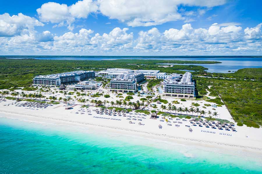 Aerial view of Majestic Elegance Costa Mujeres along a white-sand beach and turquoise water